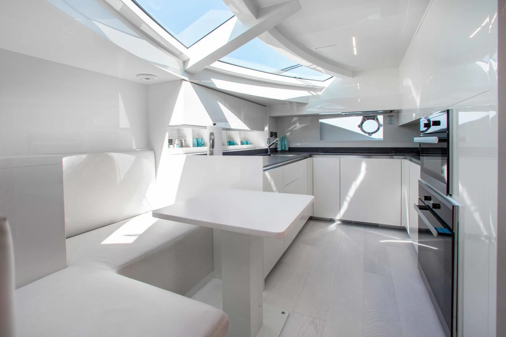 a room with a table and chairs aboard CRAZY Yacht for Sale