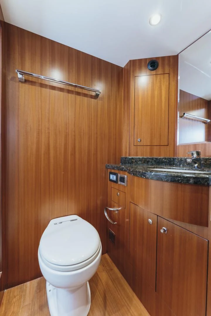 a bathroom with wooden cabinets aboard SKULLDUGGERY Yacht for Sale
