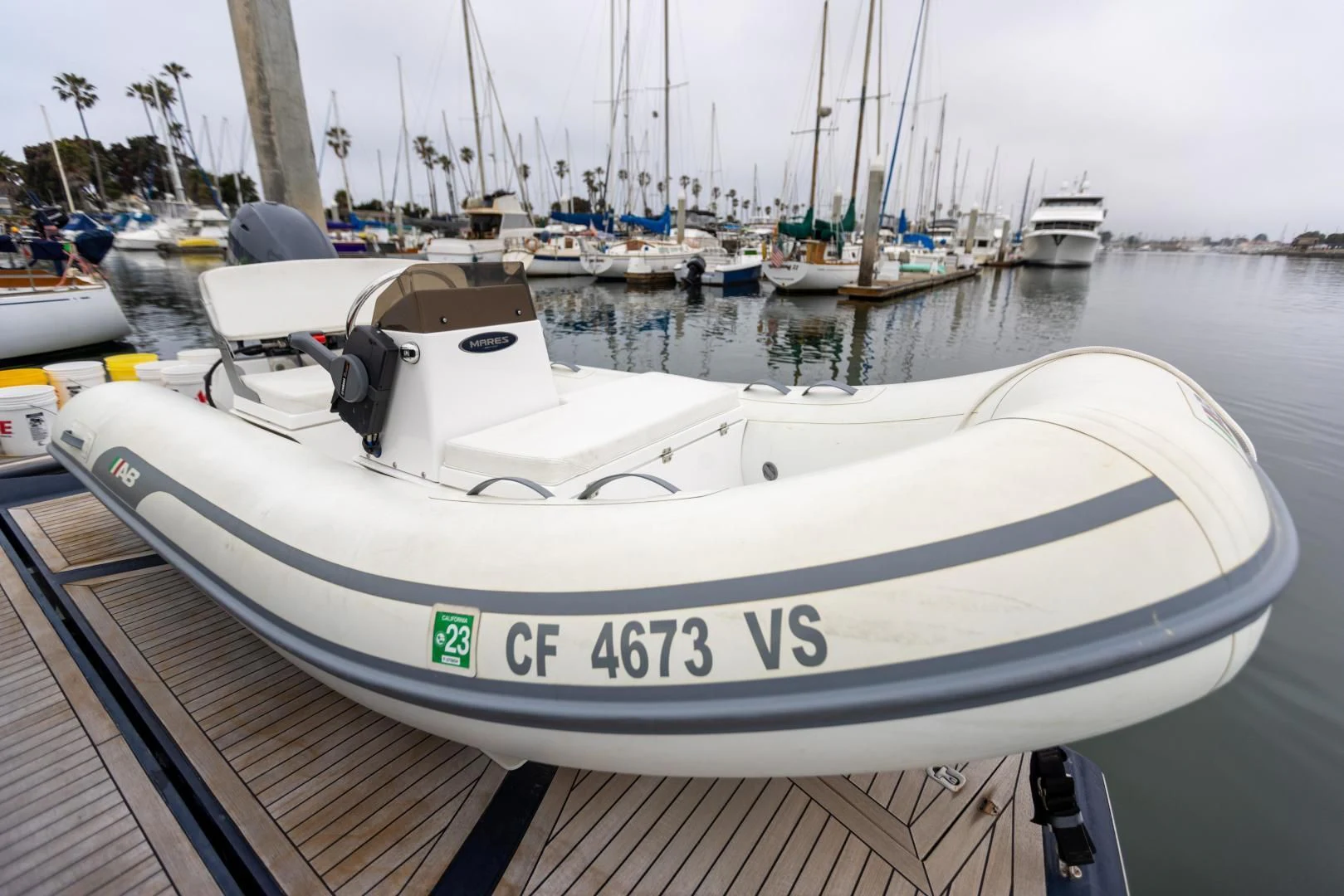 a white boat in a harbor aboard DREAM BIG Yacht for Sale