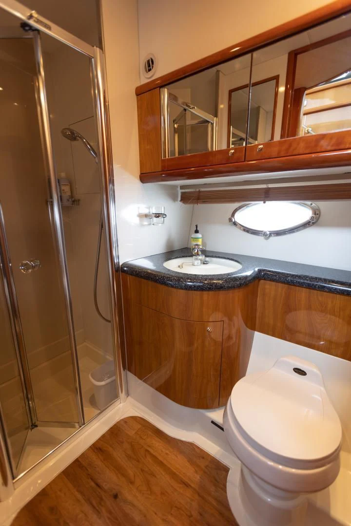 a bathroom with a glass shower door aboard DREAM BIG Yacht for Sale