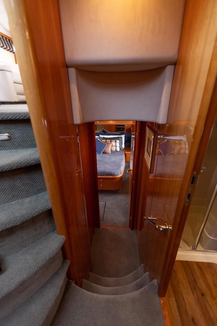 a wooden staircase with a glass door aboard DREAM BIG Yacht for Sale