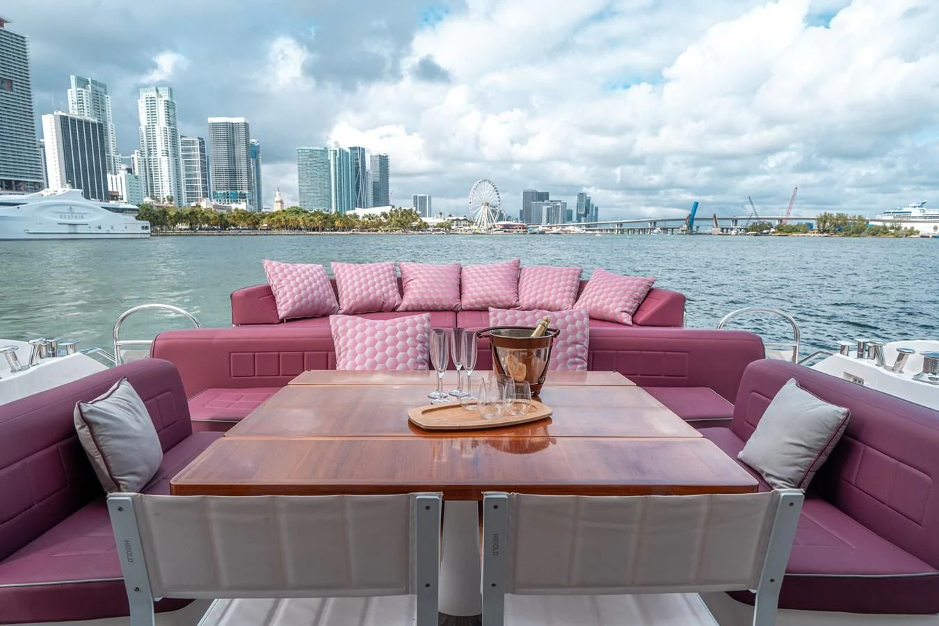 a table with chairs and a view of a city aboard SUNSEEKER 84 Yacht for Sale