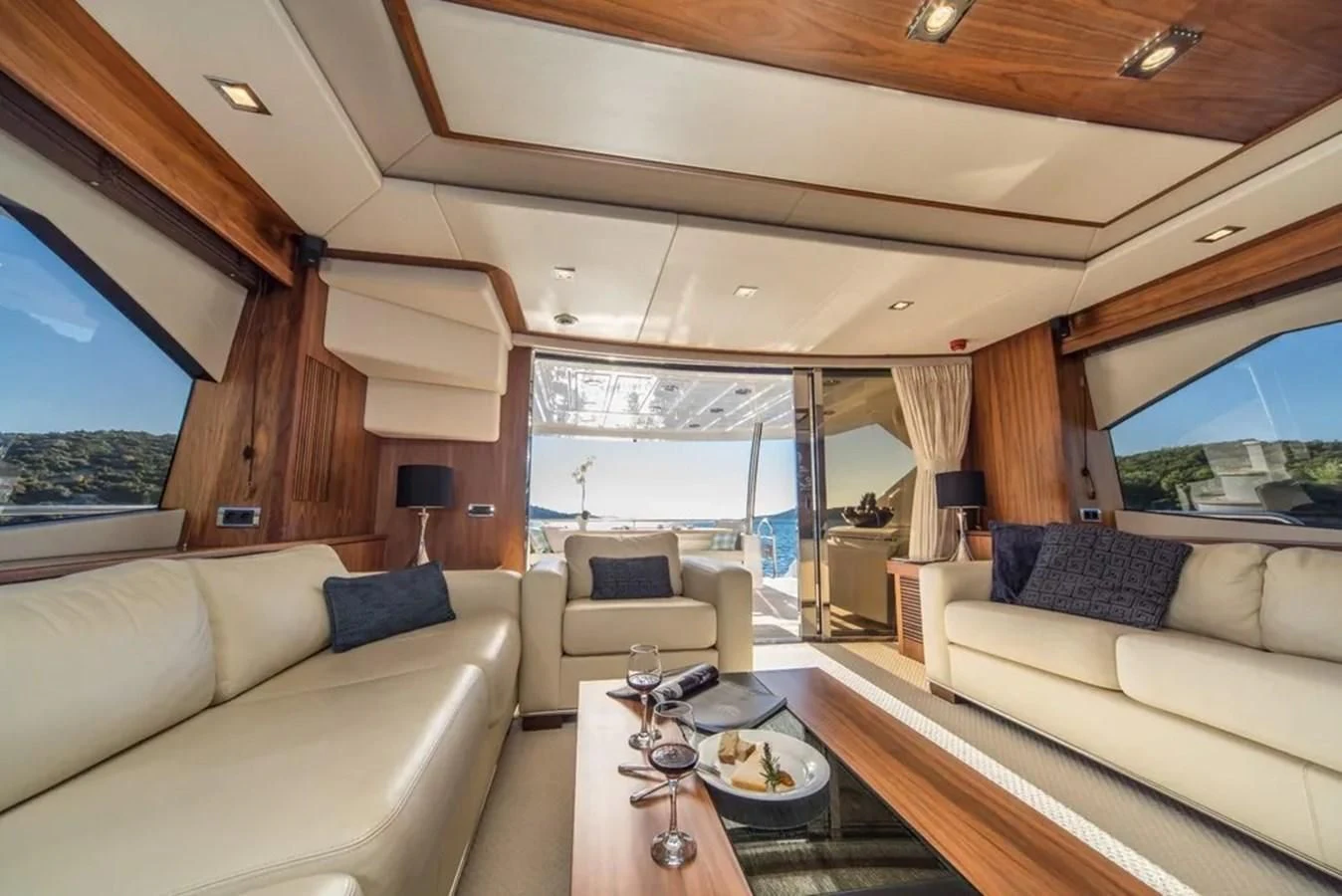 a living room with a large window aboard SUNSEEKER 84 Yacht for Sale