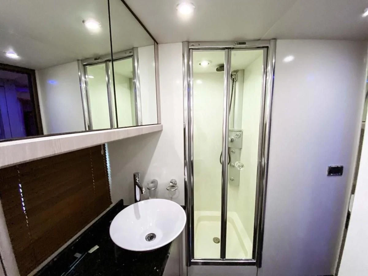 a bathroom with a glass shower aboard SUNSEEKER 84 Yacht for Sale