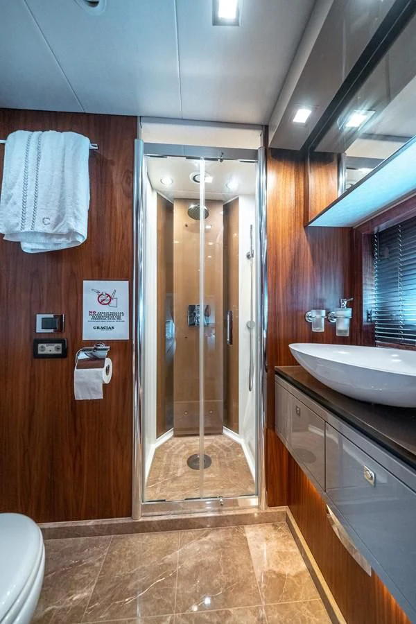 a bathroom with a glass shower door aboard SUNSEEKER 84 Yacht for Sale