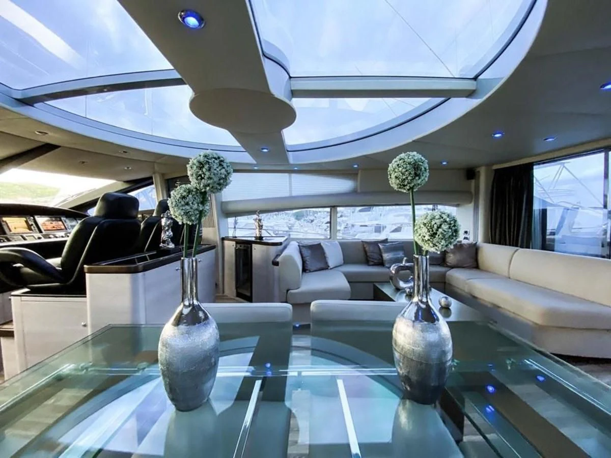 a large room with a large glass table and a vase with flowers in it aboard SUNSEEKER 84 Yacht for Sale