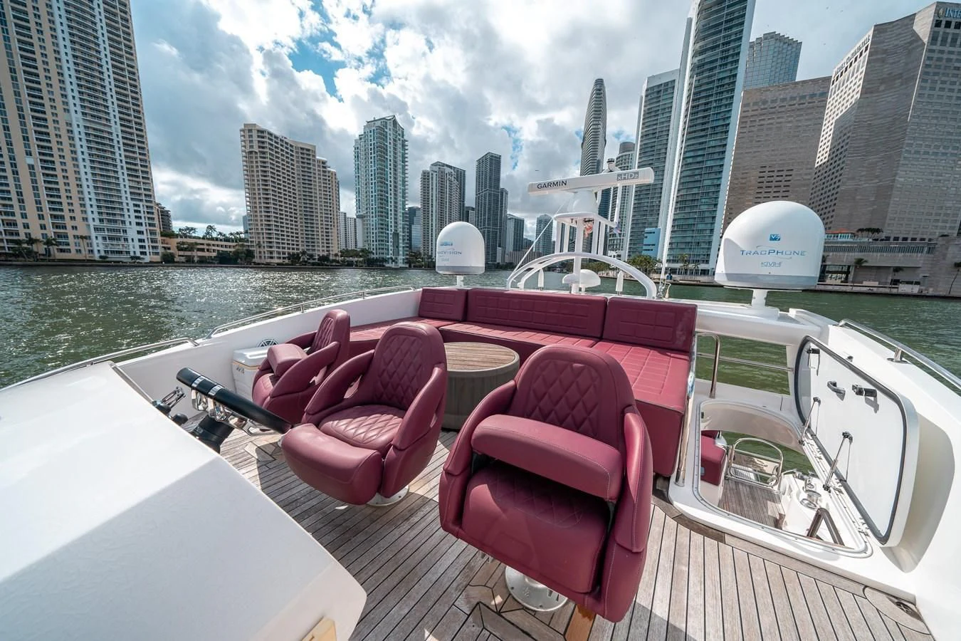 a deck with chairs and a city skyline in the background aboard SUNSEEKER 84 Yacht for Sale