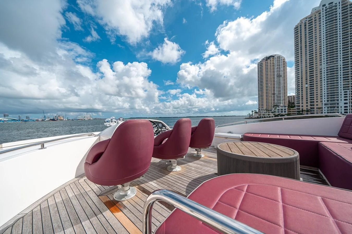 a group of red chairs on a deck overlooking a city aboard SUNSEEKER 84 Yacht for Sale