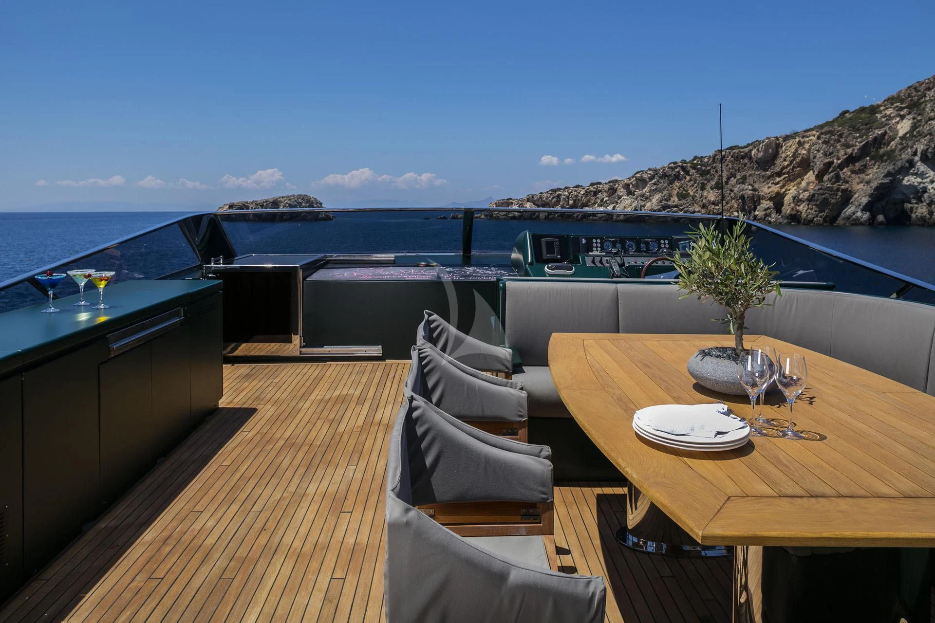 a table and chairs on a deck overlooking a large body of water aboard CAN'T REMEMBER Yacht for Sale