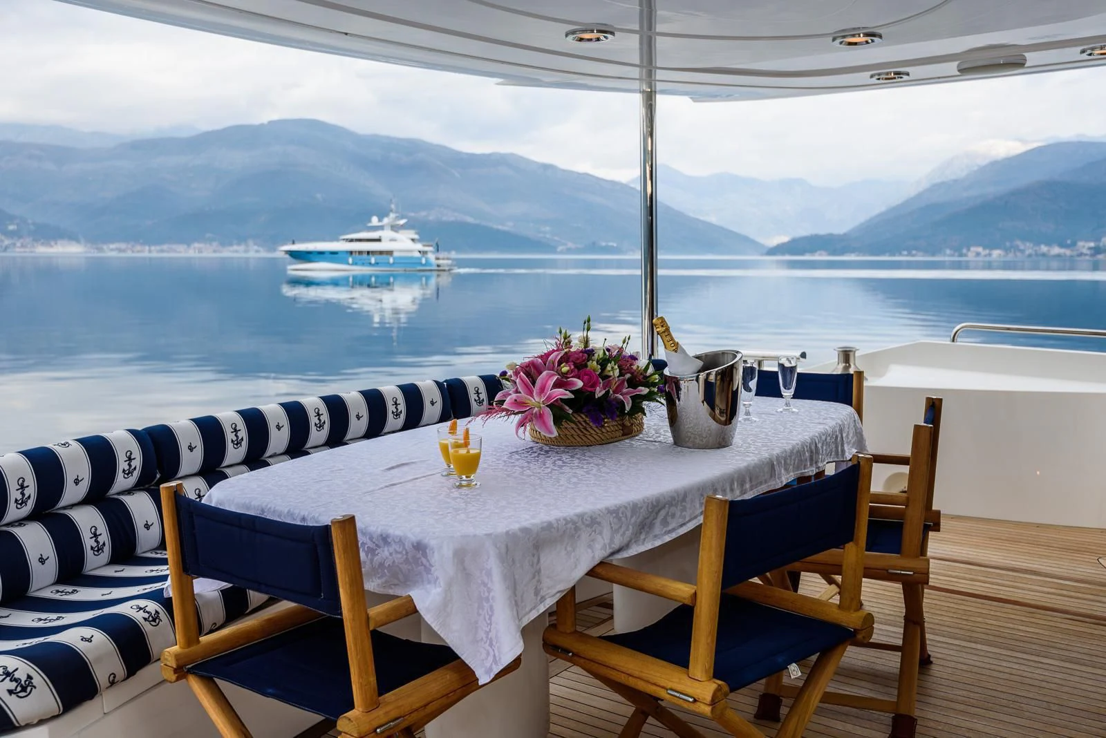 a table with chairs and a view of a city aboard CAN'T REMEMBER Yacht for Sale