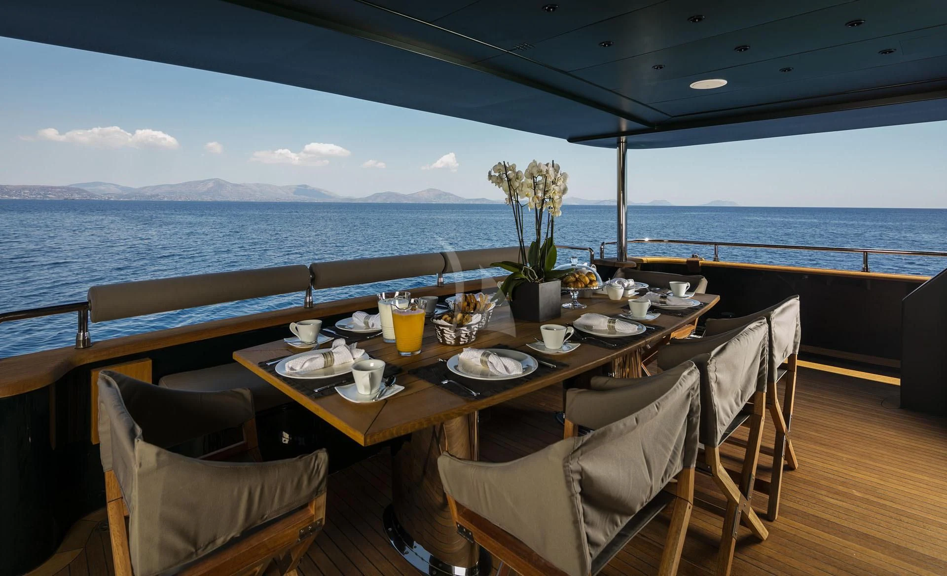 a table with chairs and a view of the ocean aboard CAN'T REMEMBER Yacht for Sale