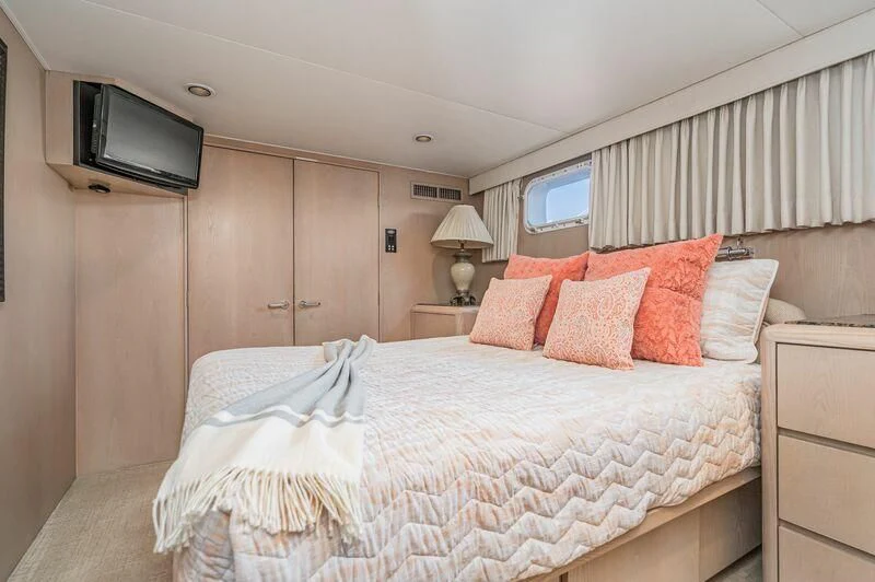 a bedroom with a bed and a television aboard PANACHE Yacht for Sale