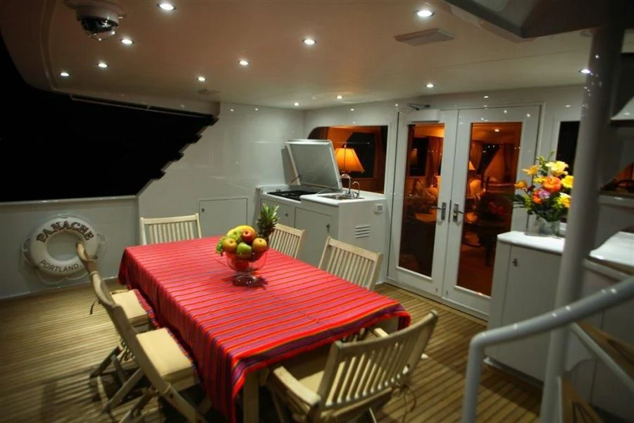 a dining room with a table and chairs aboard PANACHE Yacht for Sale