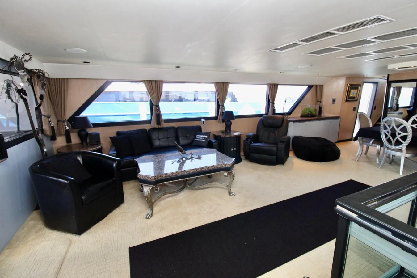 a large living room with a large window aboard PANACHE Yacht for Sale
