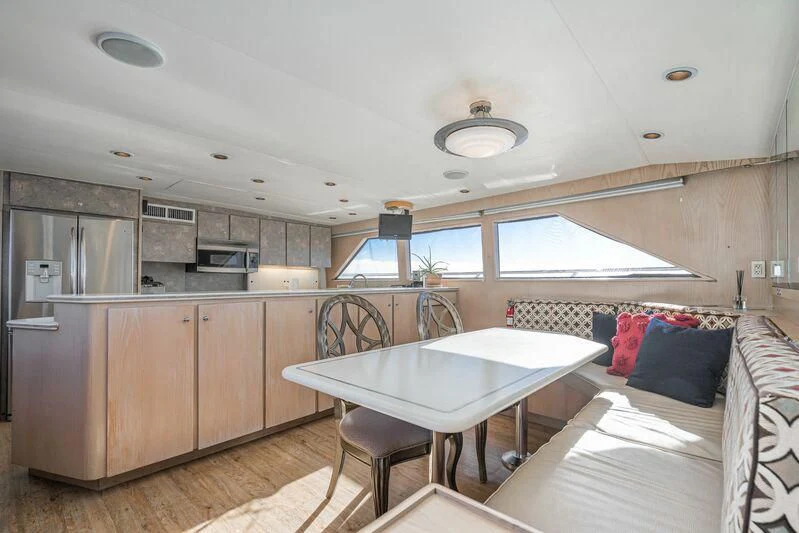 a kitchen with a table and chairs aboard PANACHE Yacht for Sale