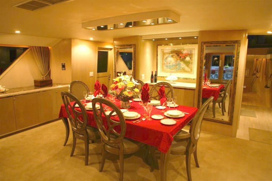 a dining room with a table and chairs aboard PANACHE Yacht for Sale
