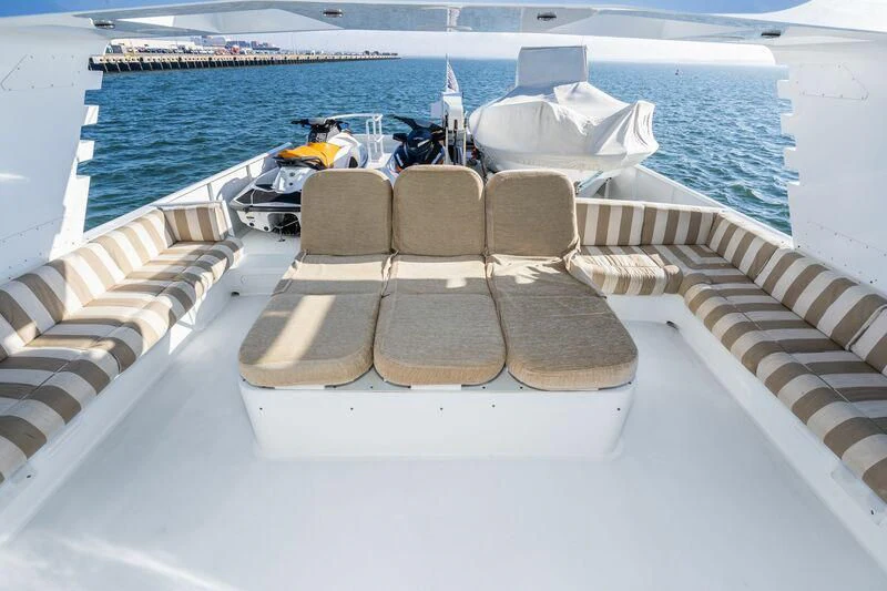a deck with chairs and a boat on it aboard PANACHE Yacht for Sale