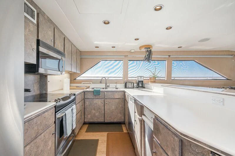 a kitchen with a stove and microwave aboard PANACHE Yacht for Sale
