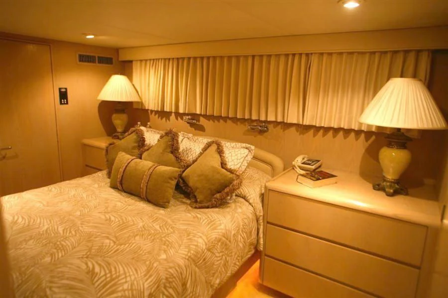 a hotel room with a bed and lamp aboard PANACHE Yacht for Sale