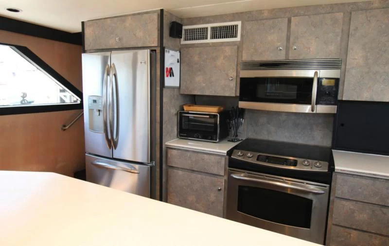 a kitchen with a refrigerator and microwave aboard PANACHE Yacht for Sale