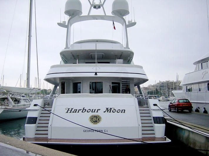 a white boat in a harbor aboard HARBOUR MOON Yacht for Sale