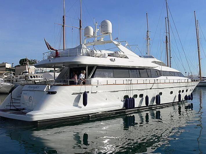 a large white boat in a harbor aboard BOJANGLES Yacht for Sale