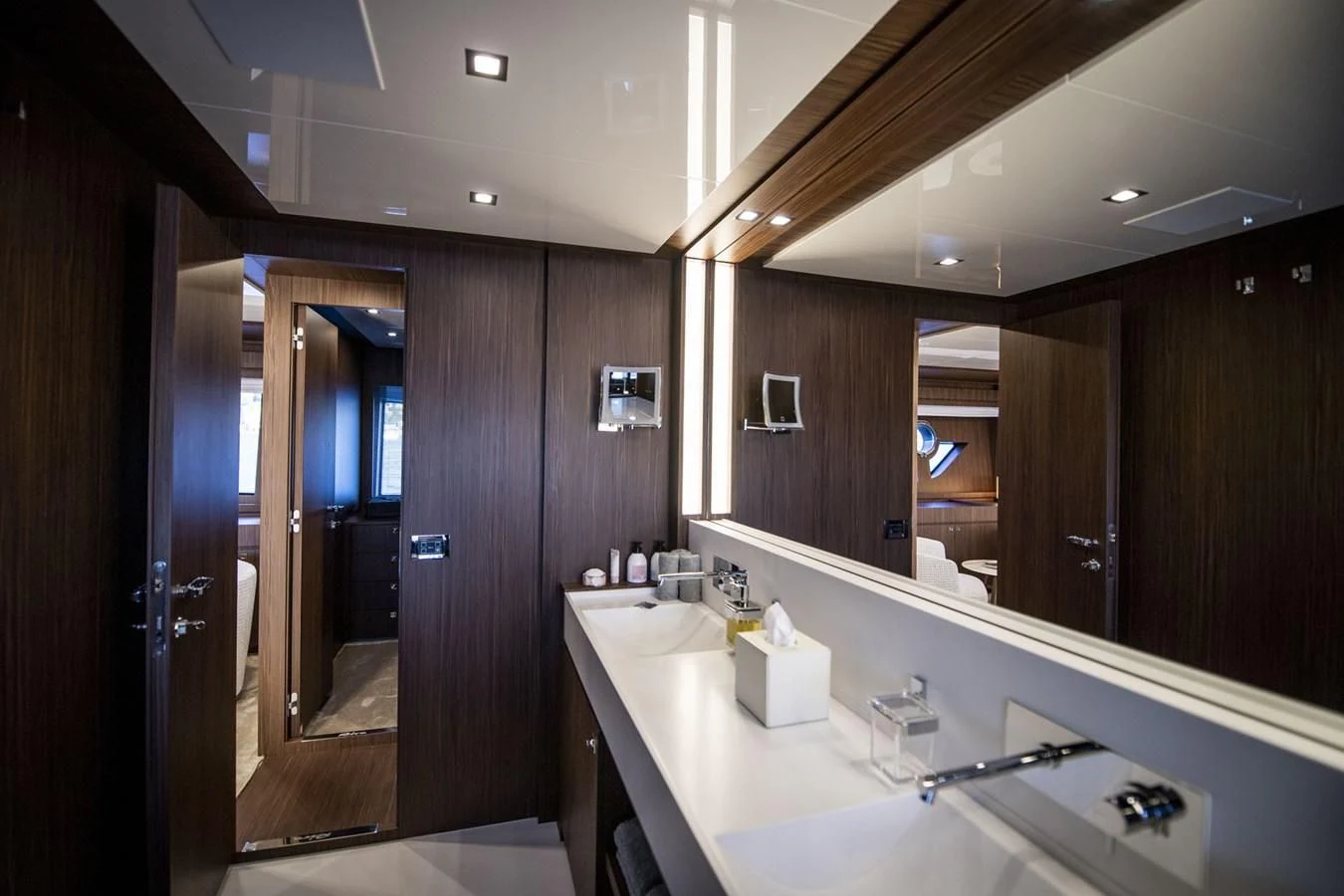 a bathroom with a countertop sink and mirrors aboard WILDONE Yacht for Sale