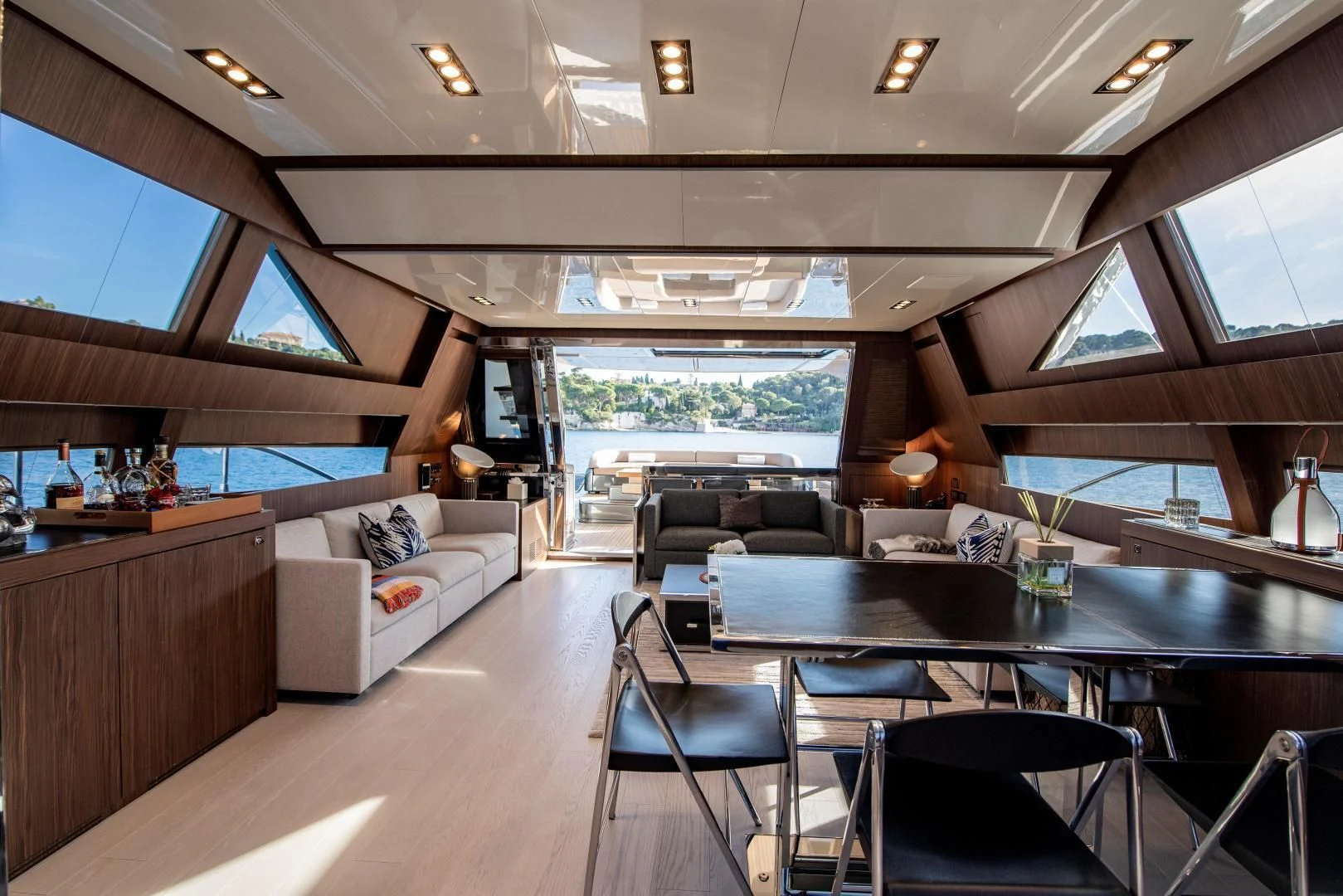 a room with a table chairs and a couch aboard WILDONE Yacht for Sale