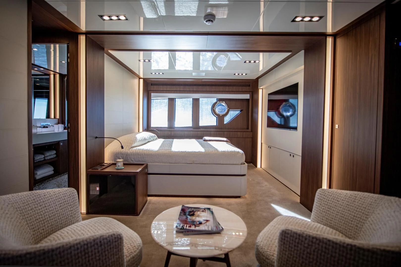 a living room with a bed and a table aboard WILDONE Yacht for Sale