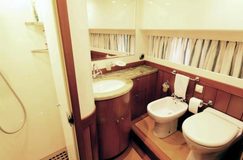 a bathroom with a toilet sink and a mirror aboard TOI MOI ET ROBY Yacht for Sale