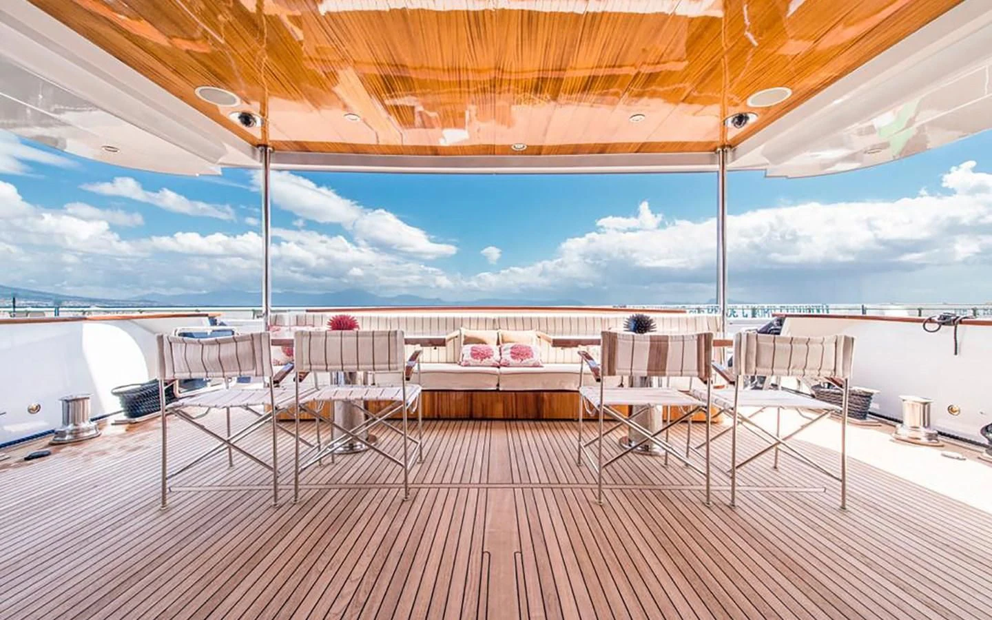 a deck with a table and chairs aboard ANGRA TOO Yacht for Sale