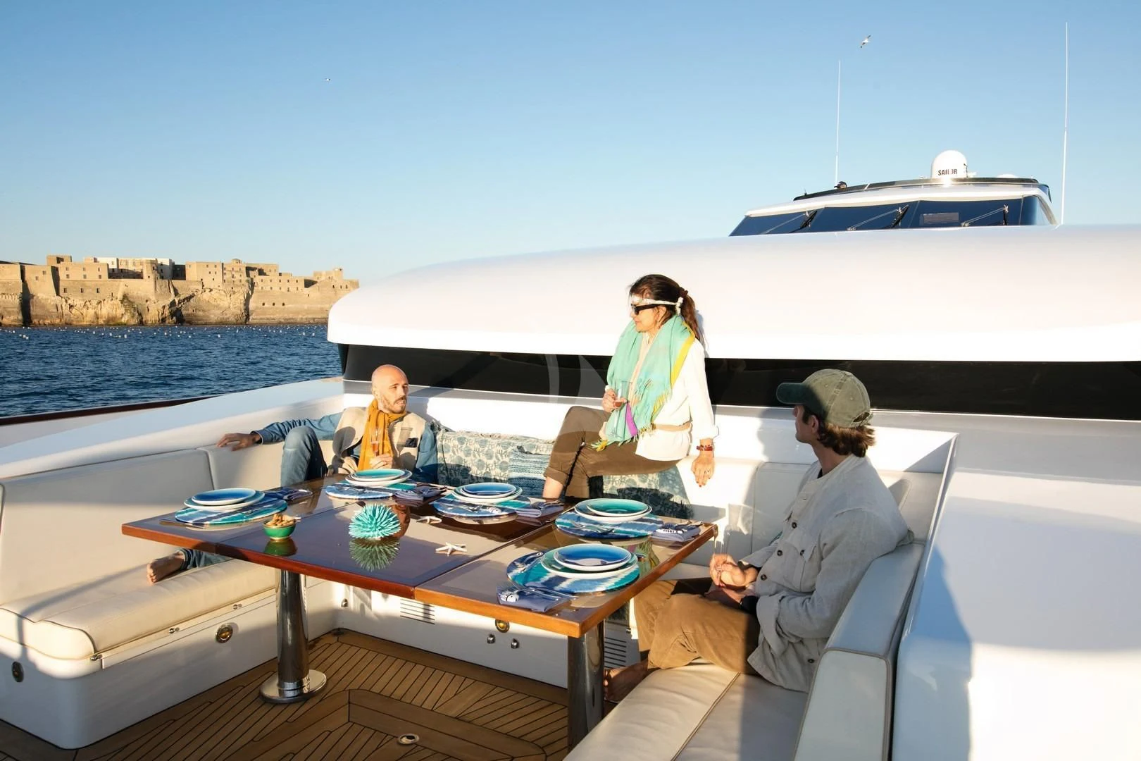a group of people sitting at a table outside aboard ANGRA TOO Yacht for Sale