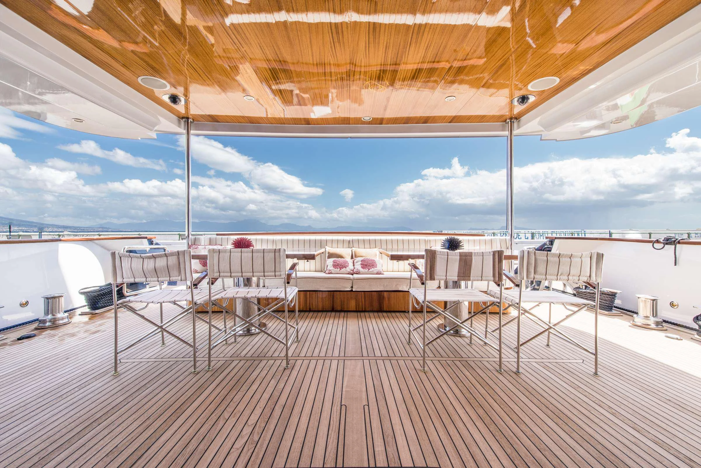 a deck with a table and chairs aboard ANGRA TOO Yacht for Sale
