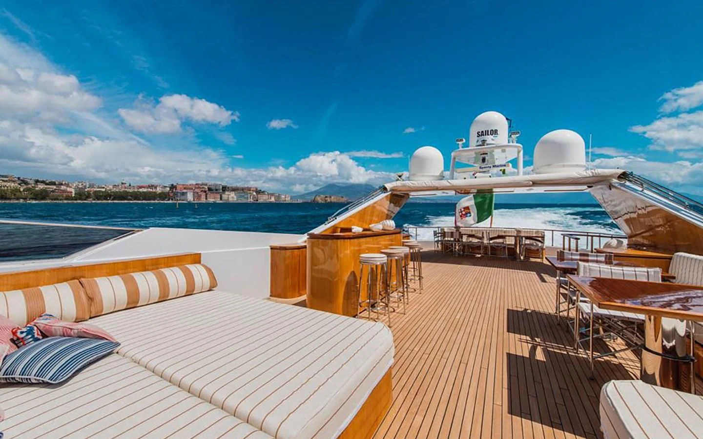 a deck with a large cruise ship in the background aboard ANGRA TOO Yacht for Sale