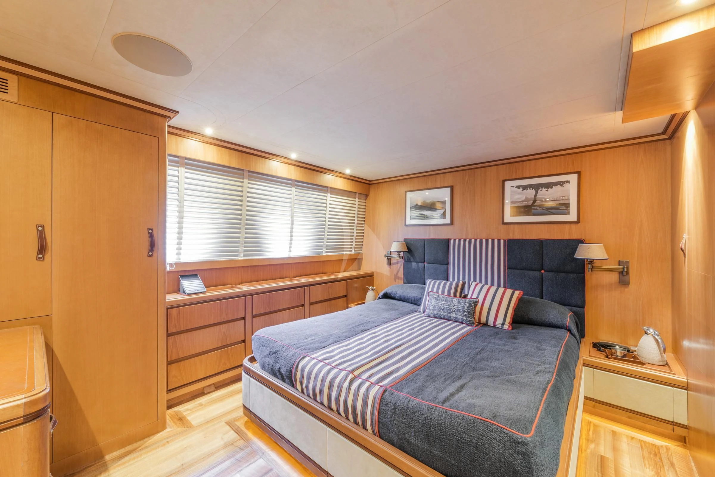 a bedroom with a bed and a closet aboard ANGRA TOO Yacht for Sale