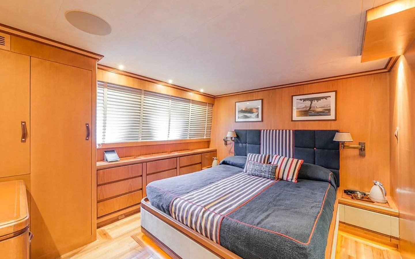 a bedroom with a bed and a desk aboard ANGRA TOO Yacht for Sale