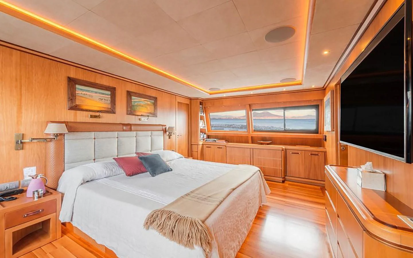 a bedroom with a bed and a desk aboard ANGRA TOO Yacht for Sale