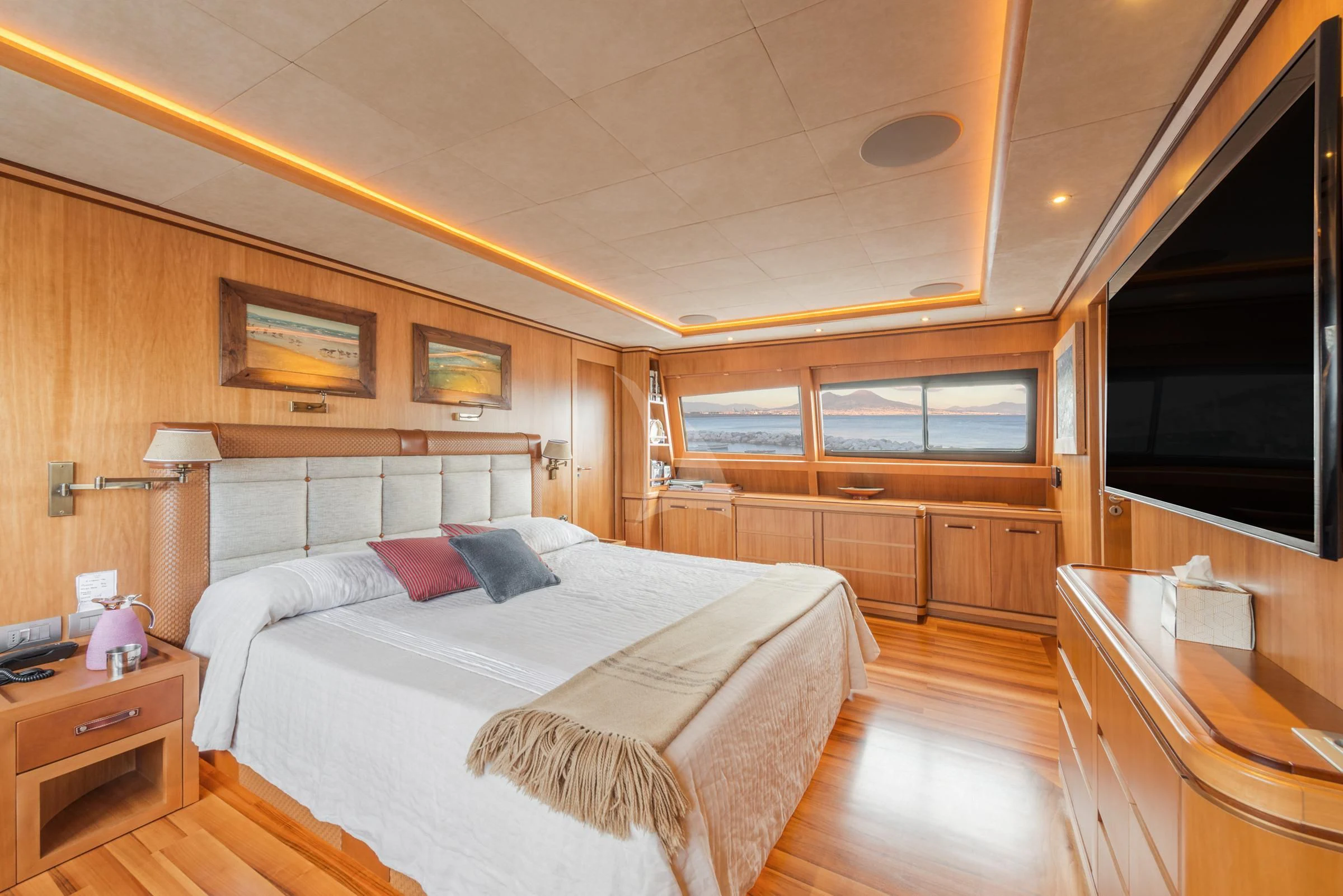 a bedroom with a bed and a desk aboard ANGRA TOO Yacht for Sale