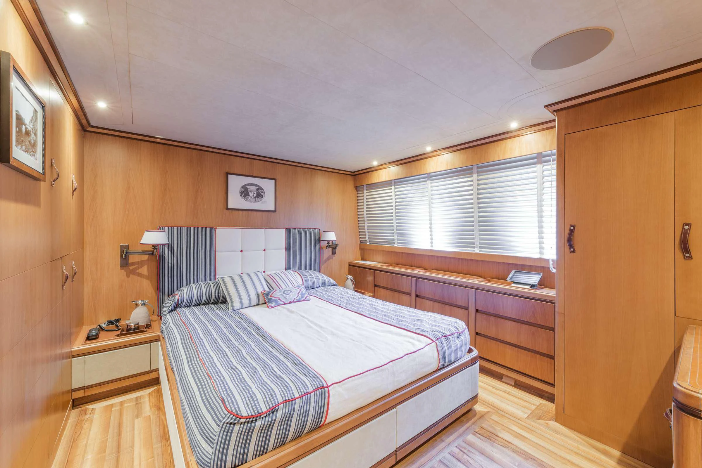 a bedroom with a bed and a desk aboard ANGRA TOO Yacht for Sale