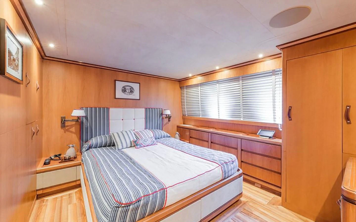 a bedroom with a bed and a wood door aboard ANGRA TOO Yacht for Sale