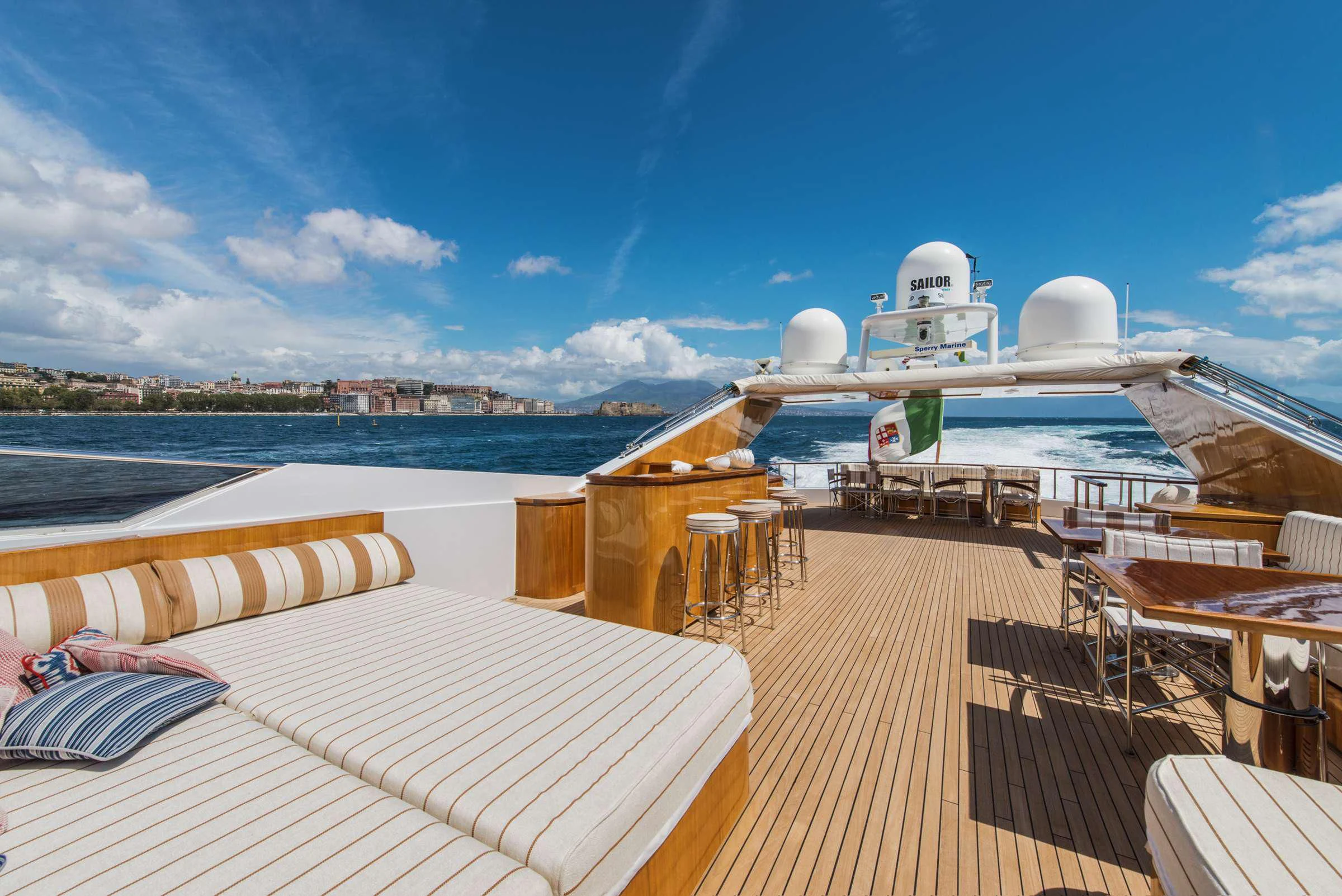 a deck with a large cruise ship in the background aboard ANGRA TOO Yacht for Sale