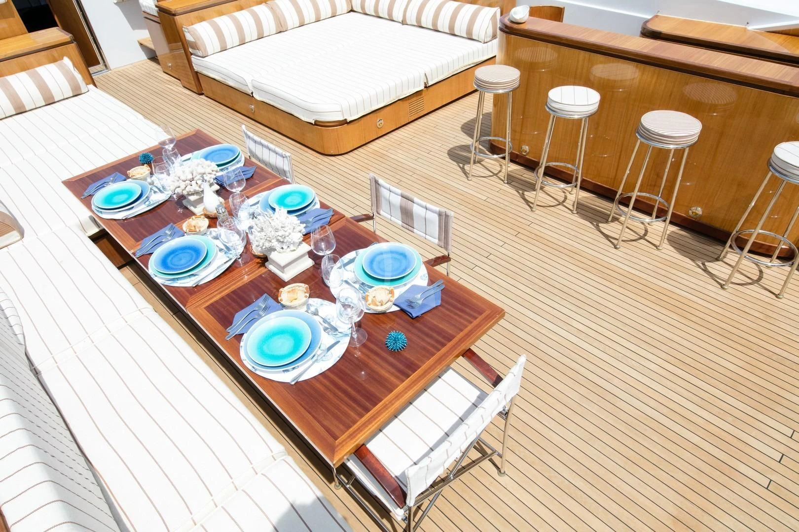 a table with plates and cups on it aboard ANGRA TOO Yacht for Sale