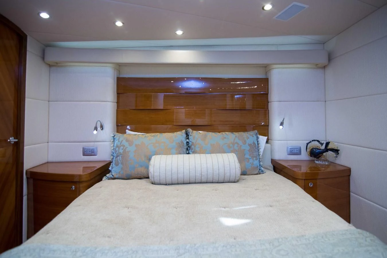 a bed with a white pillow aboard PREDATOR Yacht for Sale