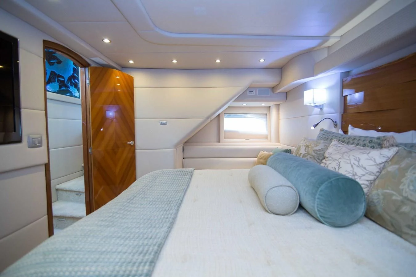 a bedroom with a bed and a door aboard PREDATOR Yacht for Sale