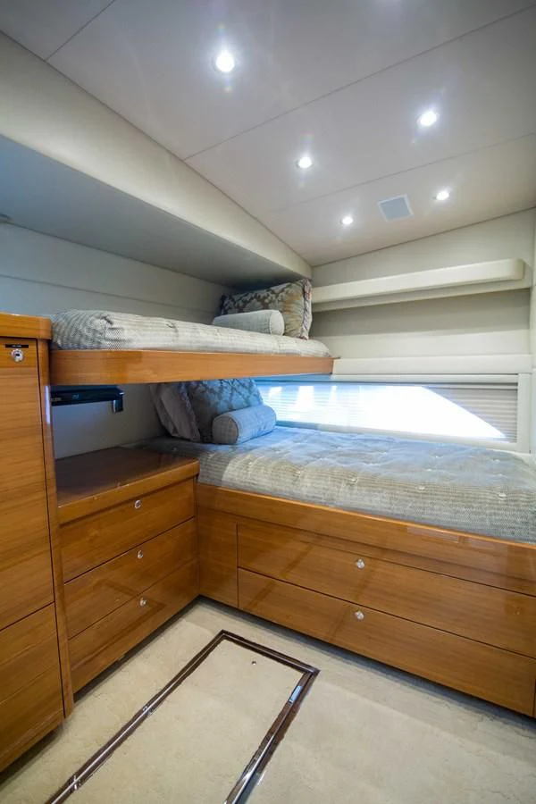 a bed with a wooden frame aboard PREDATOR Yacht for Sale