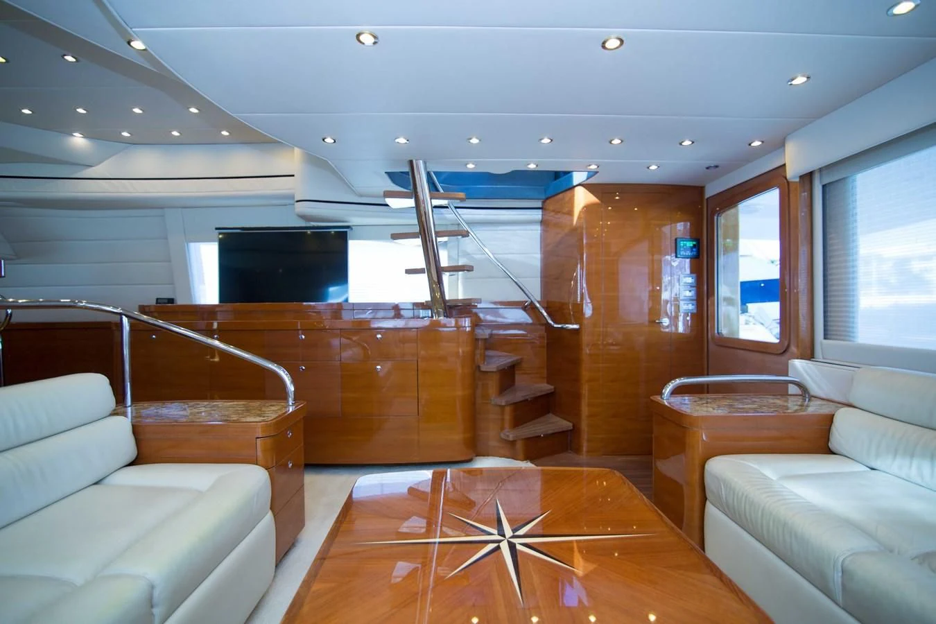 a room with a couch and a television aboard PREDATOR Yacht for Sale