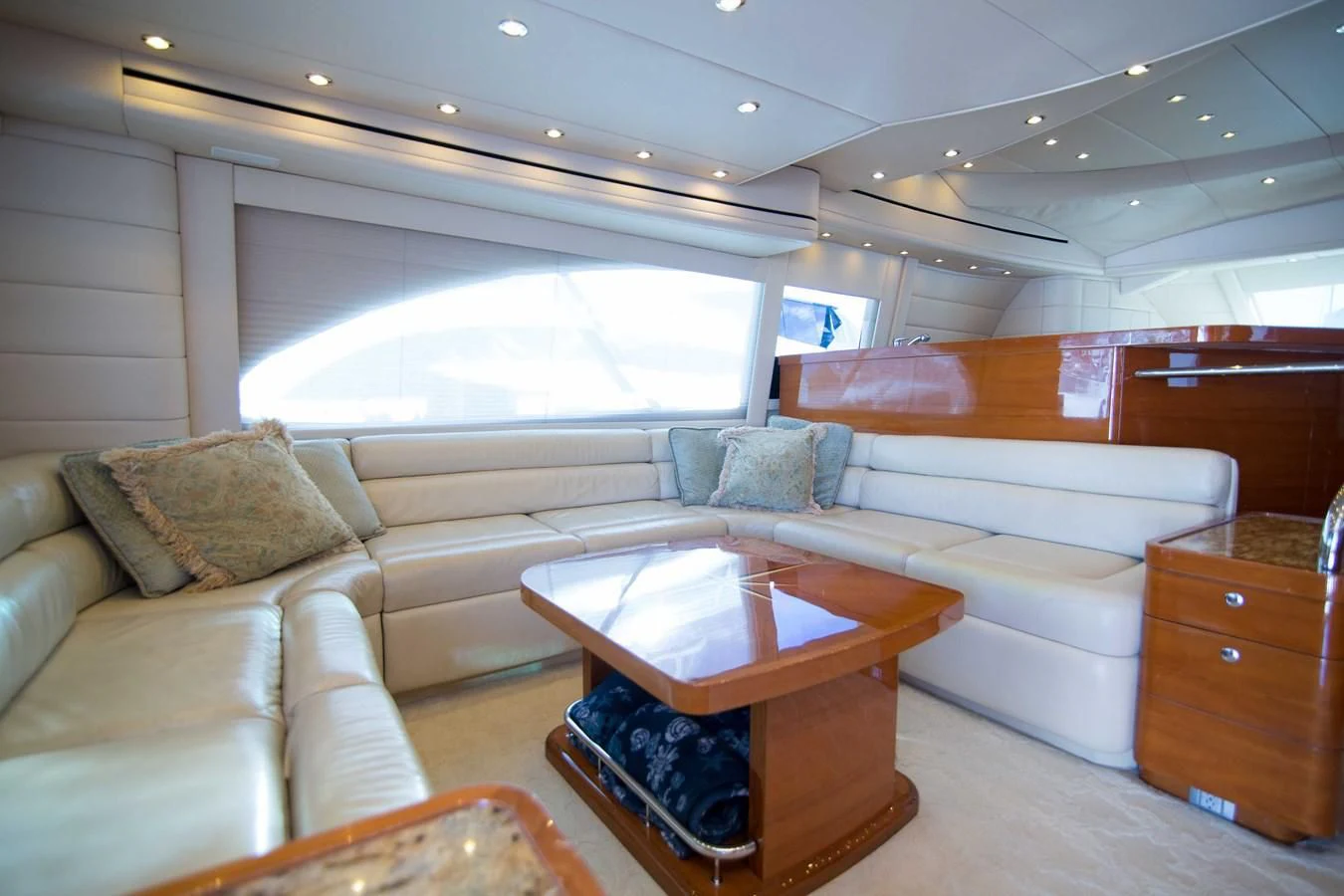 a living room with a couch and a coffee table aboard PREDATOR Yacht for Sale