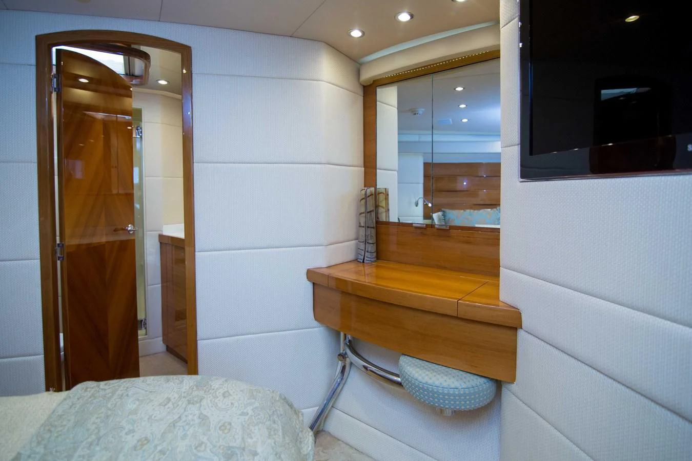 a room with a bed and a mirror aboard PREDATOR Yacht for Sale