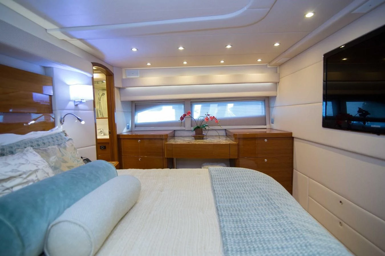 a bedroom with a bed and a tv aboard PREDATOR Yacht for Sale