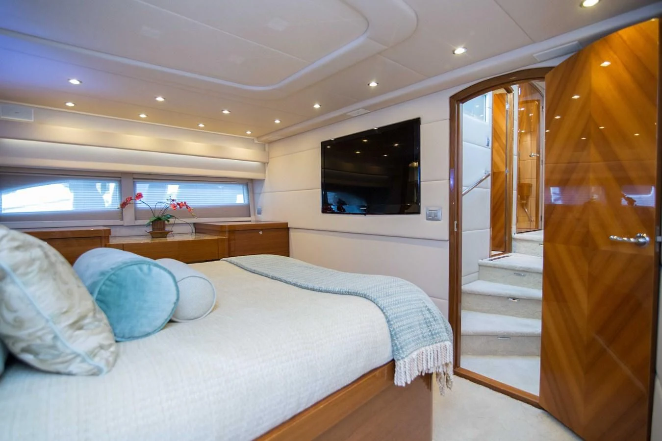 a bedroom with a bed and a television aboard PREDATOR Yacht for Sale